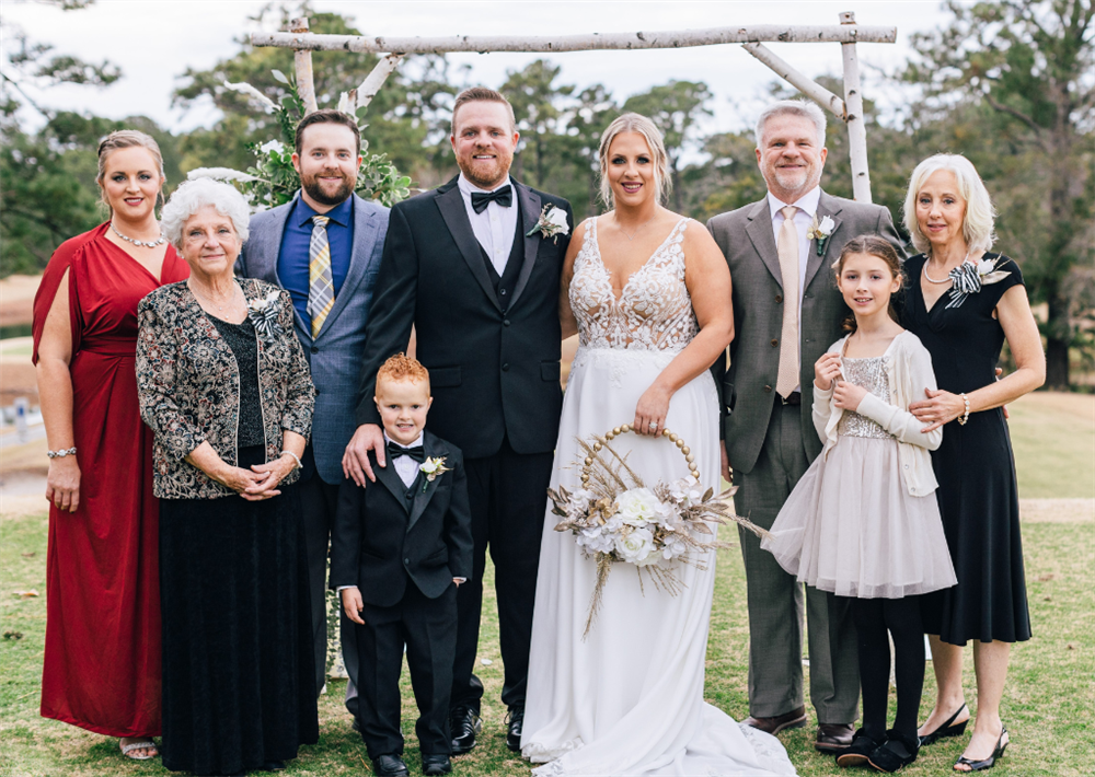 Captain Josh Henderson, Outsides Sales Representative, center, on his wedding day. From left to right, sister Rachel, grandmother Sue, brother Crockett, son Colby, Joshua, wife Madison, father Mark, daughter Olivia, and mother Audrey.